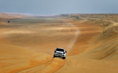 A 4x4 drives on a desert road the Wahiba Sand desert in Oman.