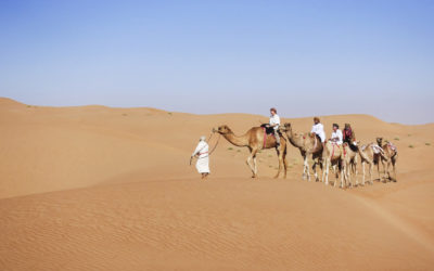 25219_017 Parts Unknown Ep 505 -  Oman Amur our bedouin friend leads the camel caravan, riding with me is British Explorer Marc Evans & his companion Mohammad, and Camel trainer Ahmed brings up the rear DSC00868.JPG